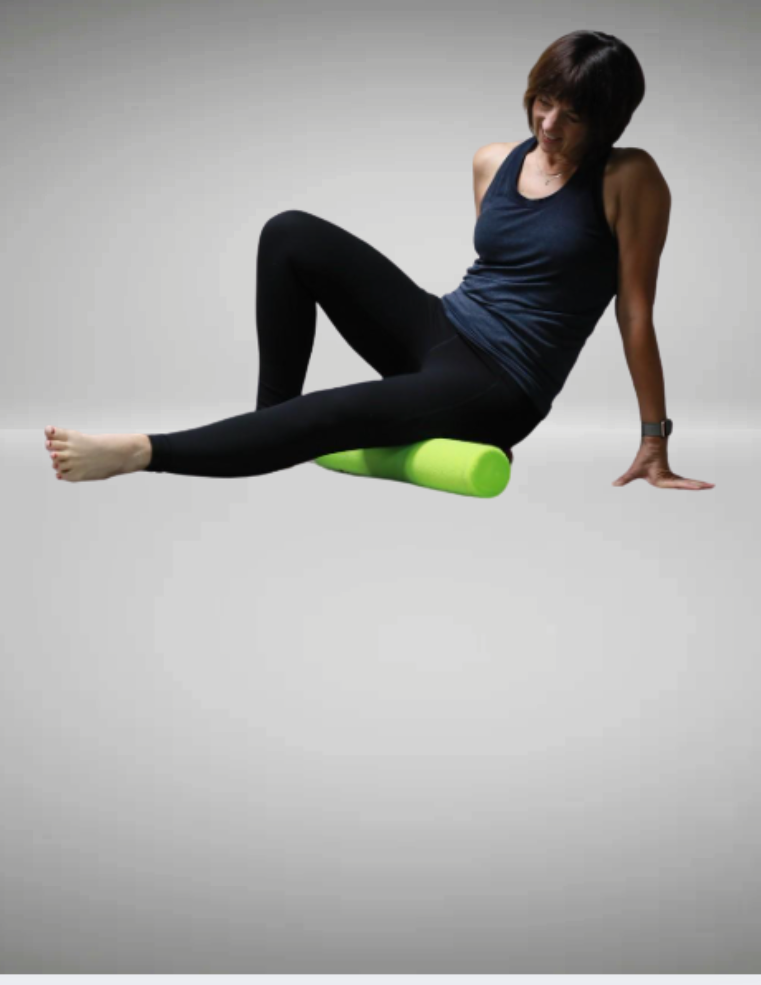 Member using a foam roller to release muscle tension after a workout at Summit Athletic Club